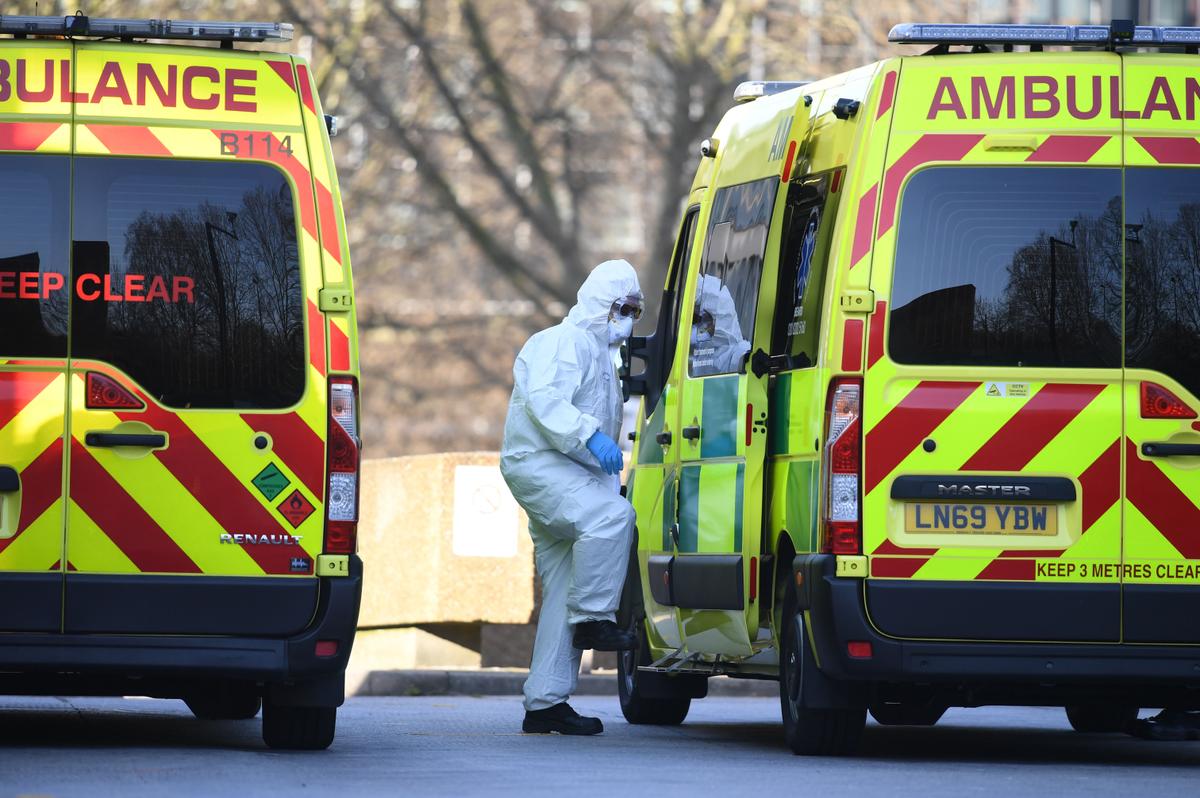 A member of the ambulance service leads a patient into an ambulance at St Thomas' Hospital in London on March 24, 2020. (©Getty Images | <a href="https://www.gettyimages.com/detail/news-photo/member-of-the-ambulance-service-wearing-personal-protective-news-photo/1208087444?adppopup=true">DANIEL LEAL-OLIVAS</a>)