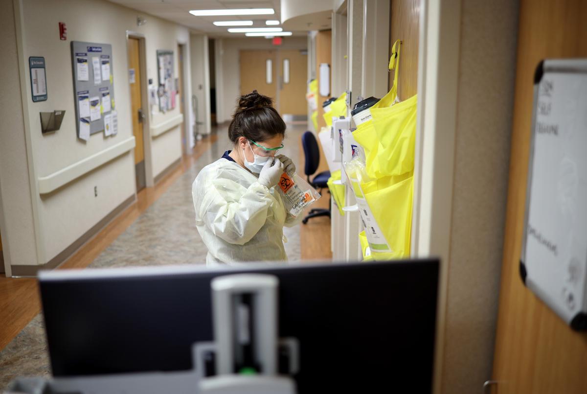 Nurses in the COVID-19 unit of MedStar St. Mary's Hospital check the fit of protective equipment before entering a patient's room in Leonardtown, Maryland, on March 24, 2020. (Win McNamee/Getty Images)