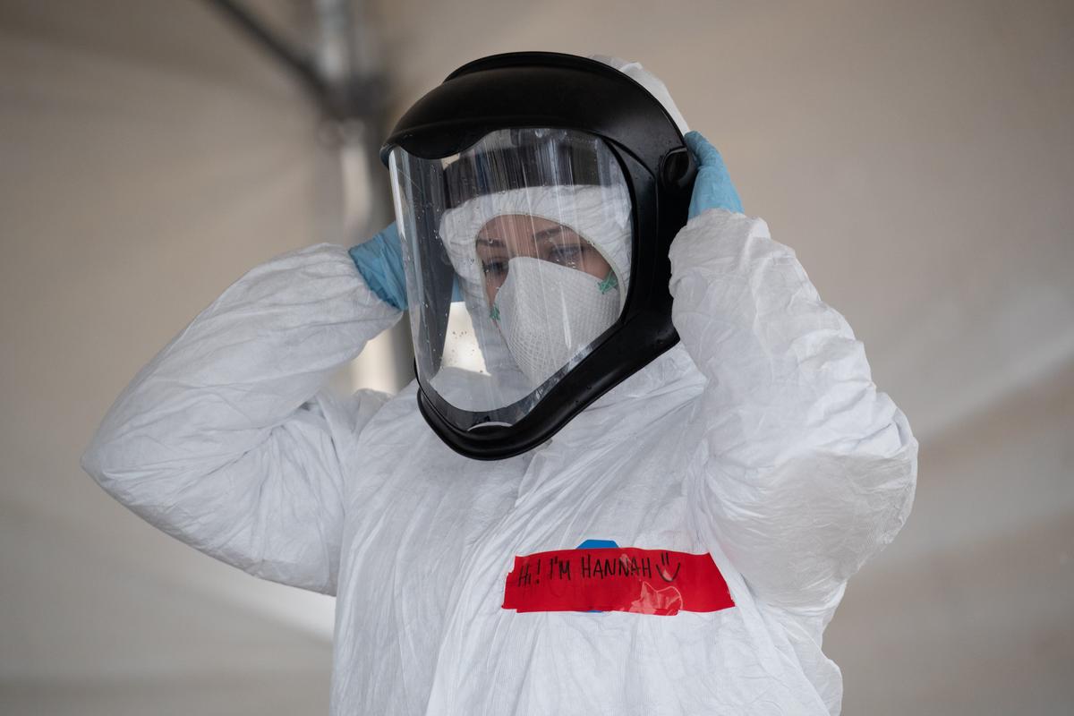 A nurse adjusts her personal protective equipment (PPE) at a COVID-19 testing station in Stamford, Connecticut, on March 23, 2020. (John Moore/Getty Images)