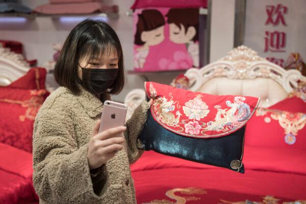 A Webcasting Hostess presents goods via online live broadcast in Hankou north international commodity exchange center in Wuhan, Hubei Province, China, on March 29,2020. (Getty Images)