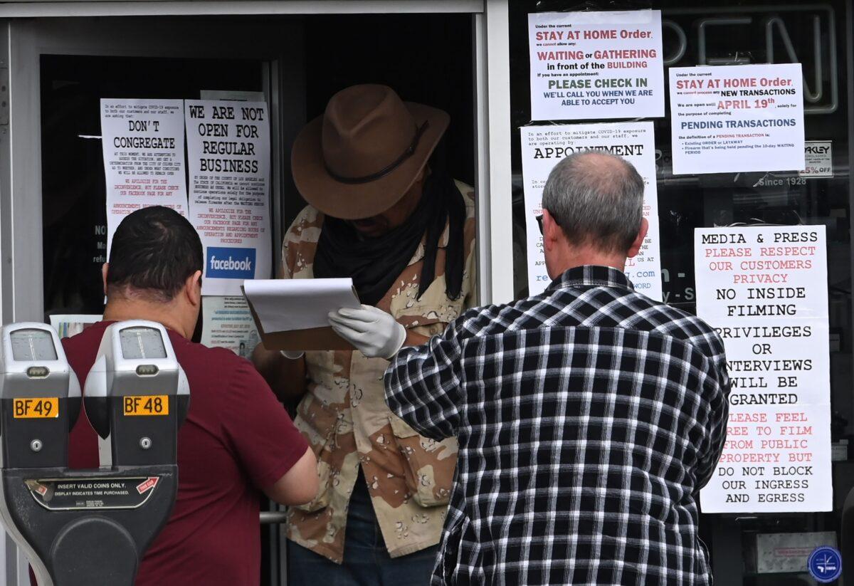 People wait to check in for their appointment to enter Martin B. Retting gun shop in Culver City, California on March 24, 2020. (Robyn Beck/AFP via Getty Images)