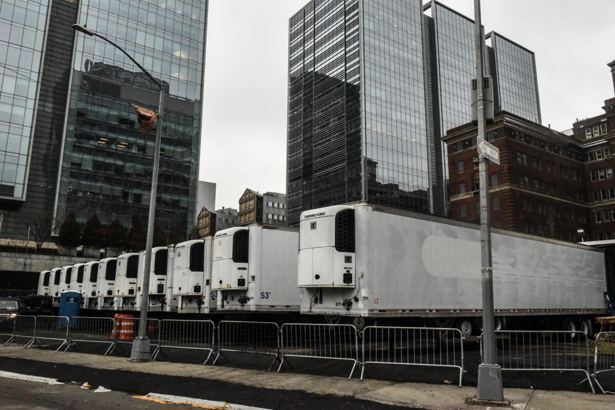 Refrigerator trucks are lined up behind NYU Langone Hospital in New York City on March 30, 2020. Due to a surge in deaths caused by the CCP virus, hospitals are using refrigerator trucks as makeshift morgues. (Stephanie Keith/Getty Images)