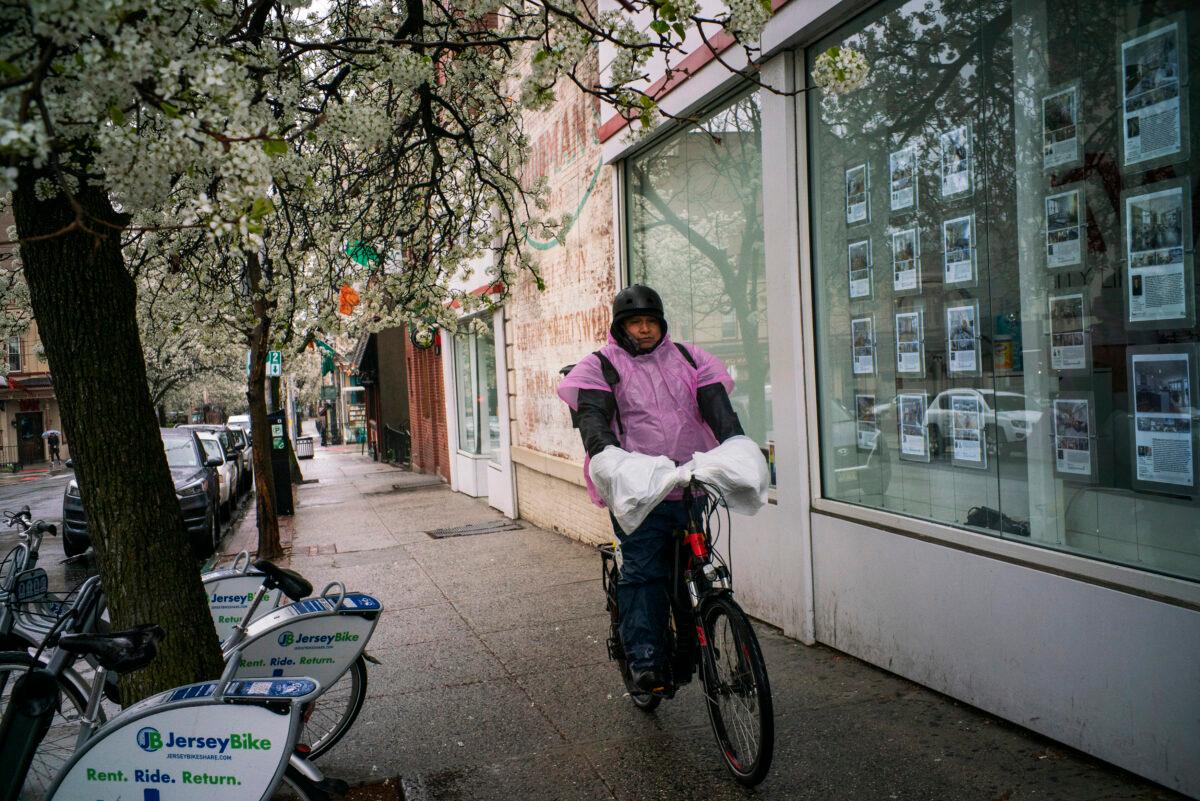 A delivery worker goes about his day during CCP virus outbreak in Hoboken, New Jersey, on March 23, 2020. (Eduardo Munoz Alvarez/Getty Images)