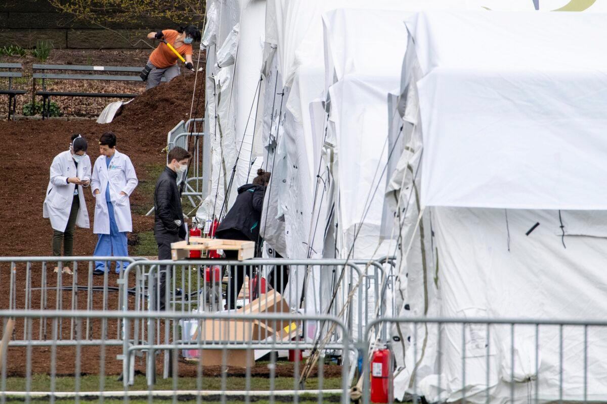 A Samaritan's Purse crew member and medical personnel work on preparing to open a 68-bed emergency field hospital specially equipped with a respiratory unit in New York's Central Park on March 31, 2020. (Mary Altaffer/AP Photo)