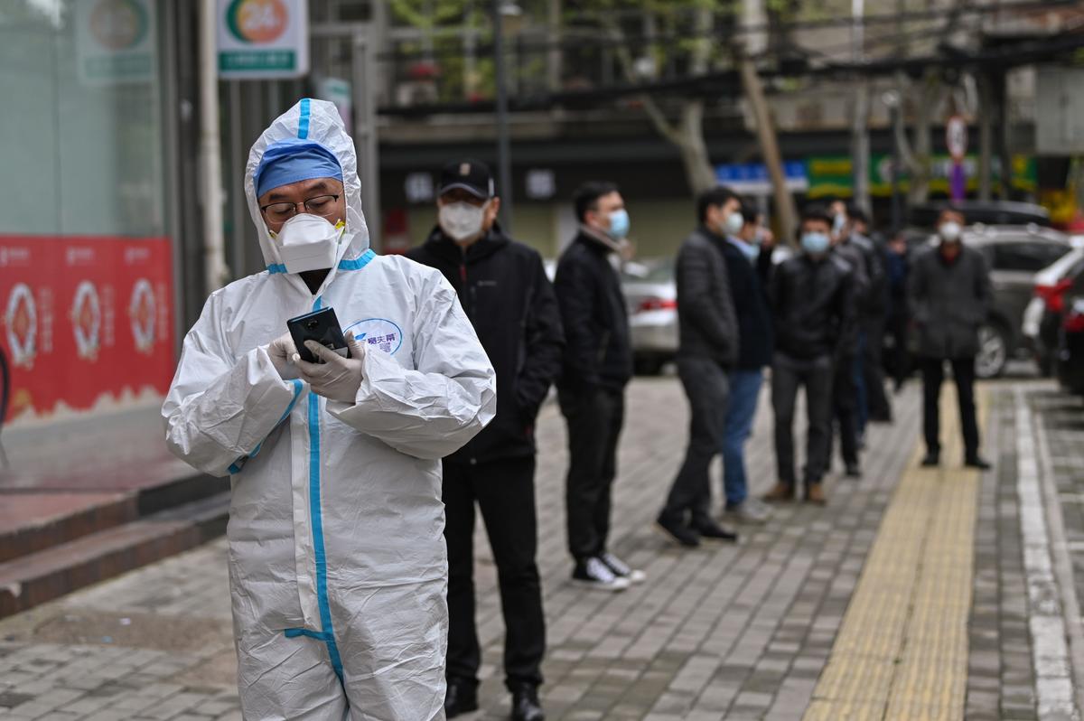 People wait to be tested for the CCP virus in Wuhan, China's central Hubei province on March 30, 2020. (HECTOR RETAMAL/AFP via Getty Images)