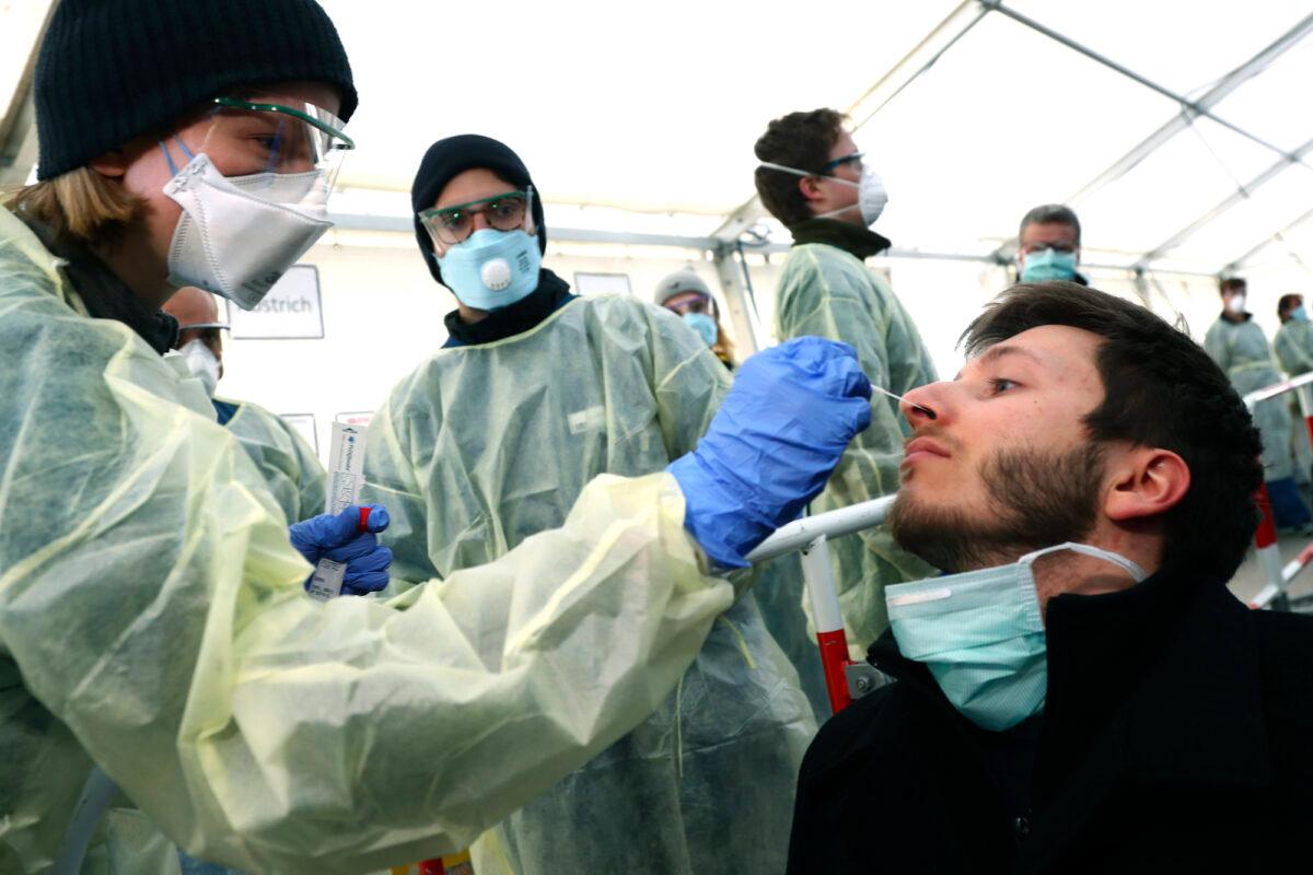 Medical staff demonstrate a COVID-19 testing workflow in Munich, Germany, on March 23, 2020. (AP Photo/Matthias Schrader)