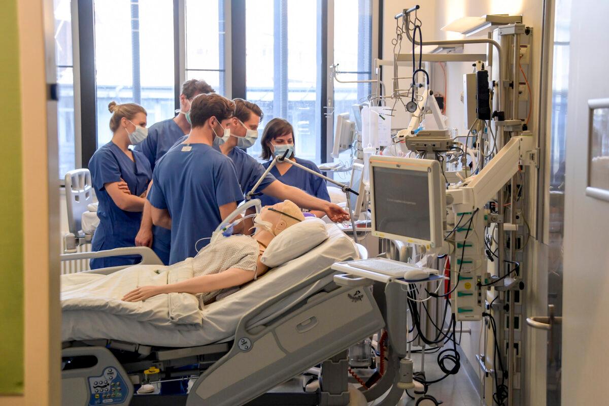 Medical staff receive operating instructions for a ventilator at a hospital in Hamburg, Germany, on March 25, 2020. (Axel Heimken/Pool Photo via AP)