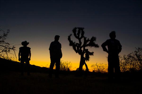 Mike Hughes, Waldo Stakes, and Patrick Marchese stand near the site of Hughes's rocket launch in Amboy, Calif., in 2018. (Toby Brusseau)