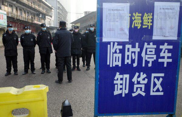 Security guards stand in front of the closed Huanan wholesale seafood market in the city of Wuhan, Hubei province, on Jan. 12, 2020. (Noel Celis/AFP via Getty Images)