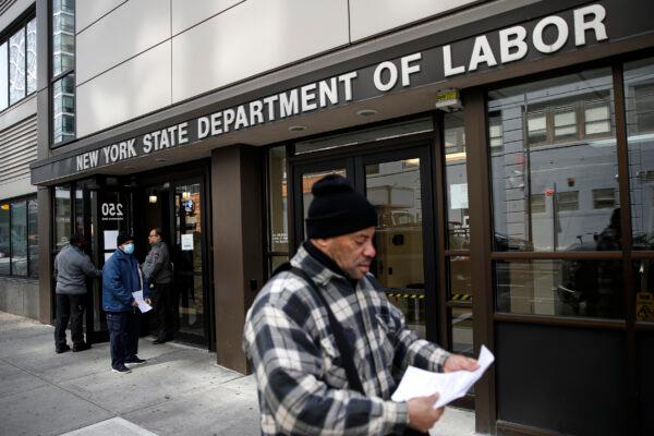 Visitors to the New York State Department of Labor are turned away at the door by personnel, due to closures over CCP virus concerns in New York City, on March 18, 2020. (John Minchillo/AP Photo)