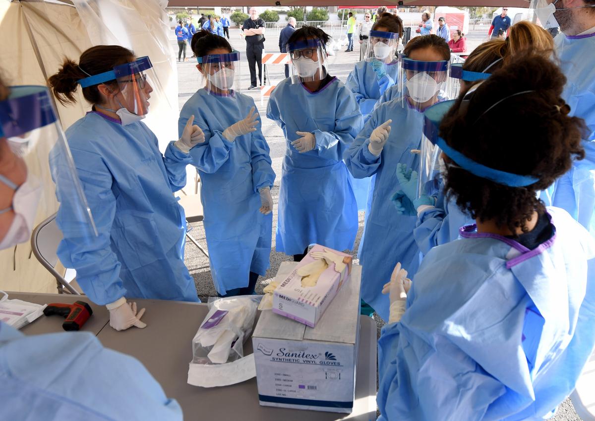 Touro University Nevada medical staff prepare to conduct screenings at a temporary homeless shelter in a parking lot at Cashman Center in Las Vegas, Nevada, on March 28, 2020. (©Getty Images | <a href="https://www.gettyimages.com/detail/news-photo/touro-university-nevada-medical-students-and-physician-news-photo/1215485949?adppopup=true">Ethan Miller</a>)