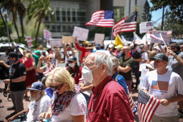 Demonstrators protest during a rally to re-open California and against Stay-At-Home directives in San Diego, Calif., on May 1, 2020. (Sandy Huffaker/AFP via Getty Images)