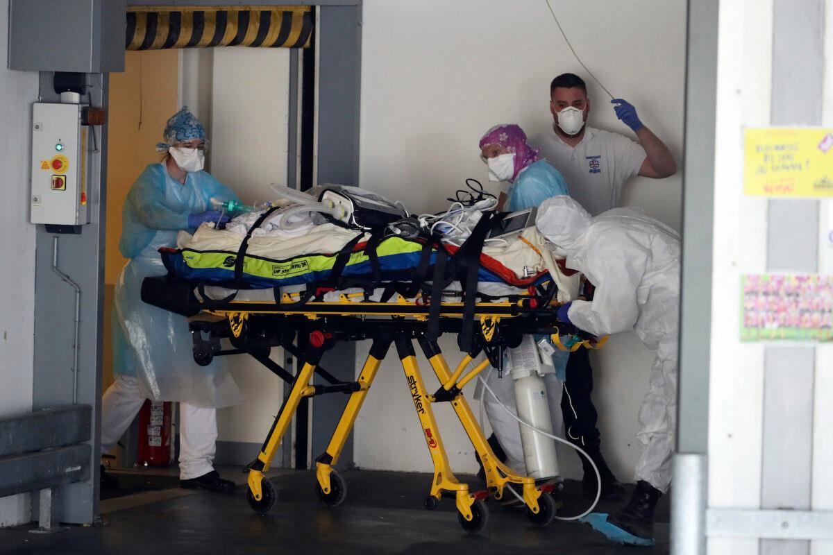 A patient infected with the COVID-19 virus is admitted to in Rennes, France, on April 1, 2020. (AP Photo/David Vincent)