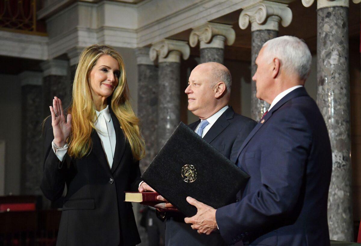 Vice President Mike Pence (R) conducts the ceremonial swearing-in of Sen. Kelly Loeffler (R-Ga.), left, as her husband Jeffrey Sprecher looks on, in the Old Senate of the US Capitol in Washington on Jan. 6, 2020. (Mandel Ngan/AFP/Getty Images)