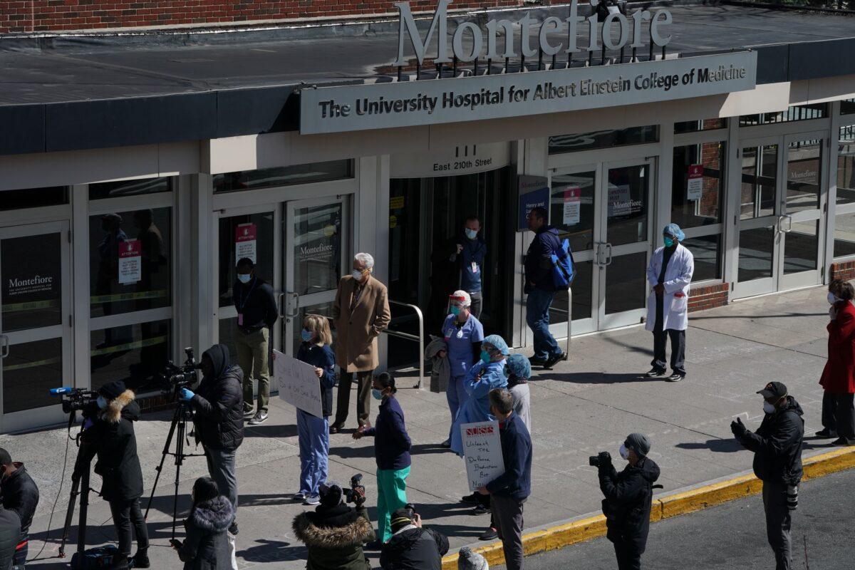 Members of the medical staff listen as Montefiore Medical Center nurses call for N95 masks and other critical PPE to handle the CCp virus pandemic in New York on April 1, 2020. (Bryan R. Smith/AFP via Getty Images)