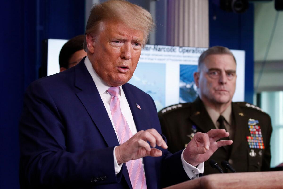 President Donald Trump speaks about the coronavirus in the James Brady Press Briefing Room of the White House on April 1, 2020, in Washington, as Chairman of the Joint Chiefs Gen. Mark Milley, listens. (Alex Brandon/AP Photo)