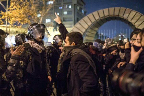 An Iranian man confronts riot police during a demonstration outside Tehran's Amir Kabir University on Jan. 11, 2020, after Iran admitted to having shot down a Ukrainian passenger jet by mistake on Jan. 8, killing all 176 people on board. (-/AFP via Getty Images)