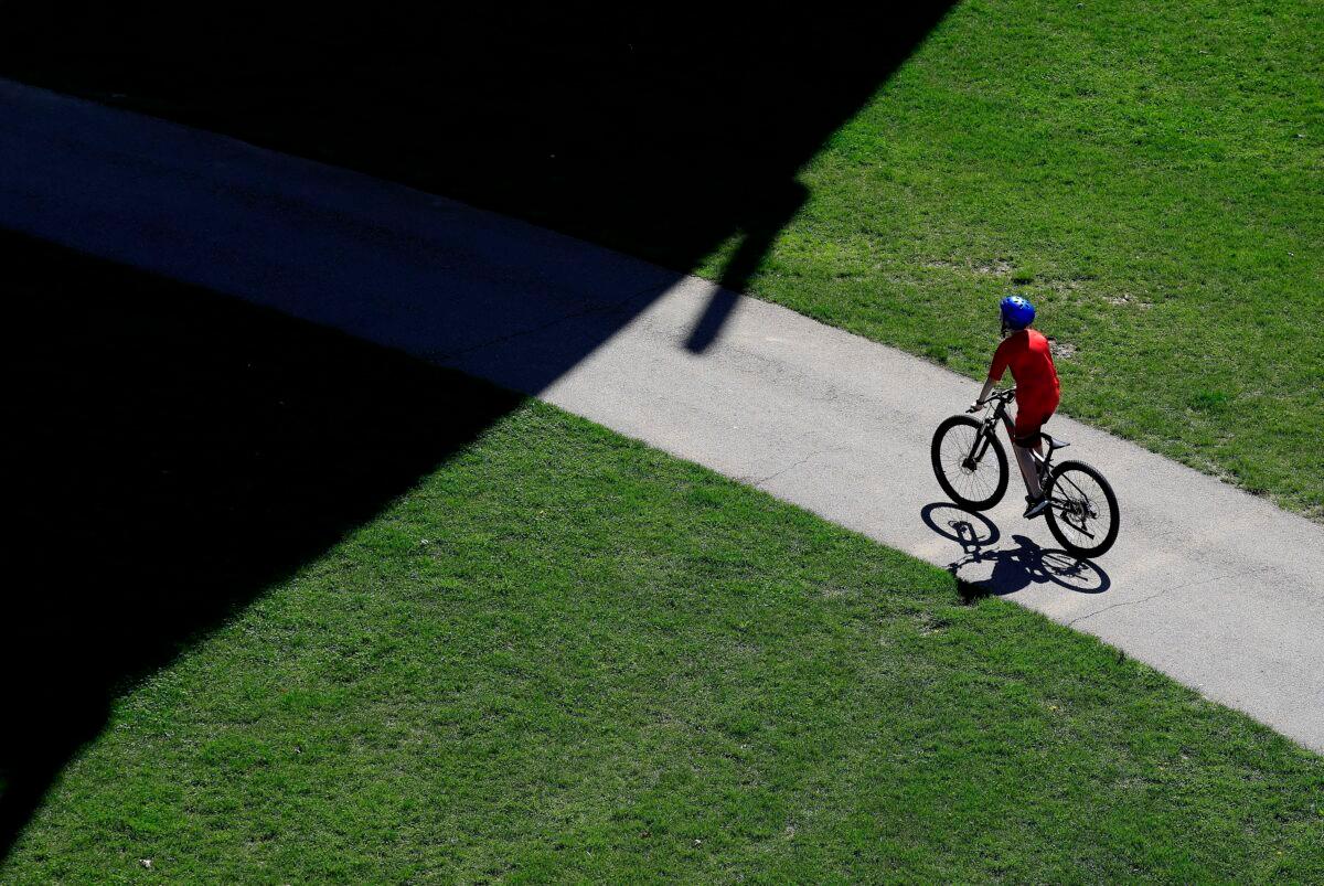 Cyclist rides at Waterfront Park in downtown Louisville, Kentucky on March 29, 2020. (Andy Lyons/Getty Images)