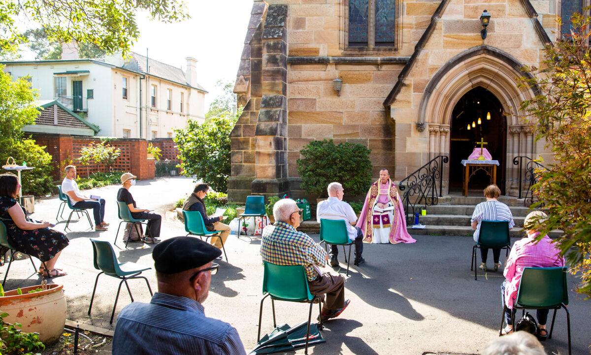 Father James Collins holds a service in the yard of St Paul's Anglican Church in Burwood with seating observant of social distancing in Sydney, Australia, on March 22, 2020. (Jenny Evans/Getty Images)