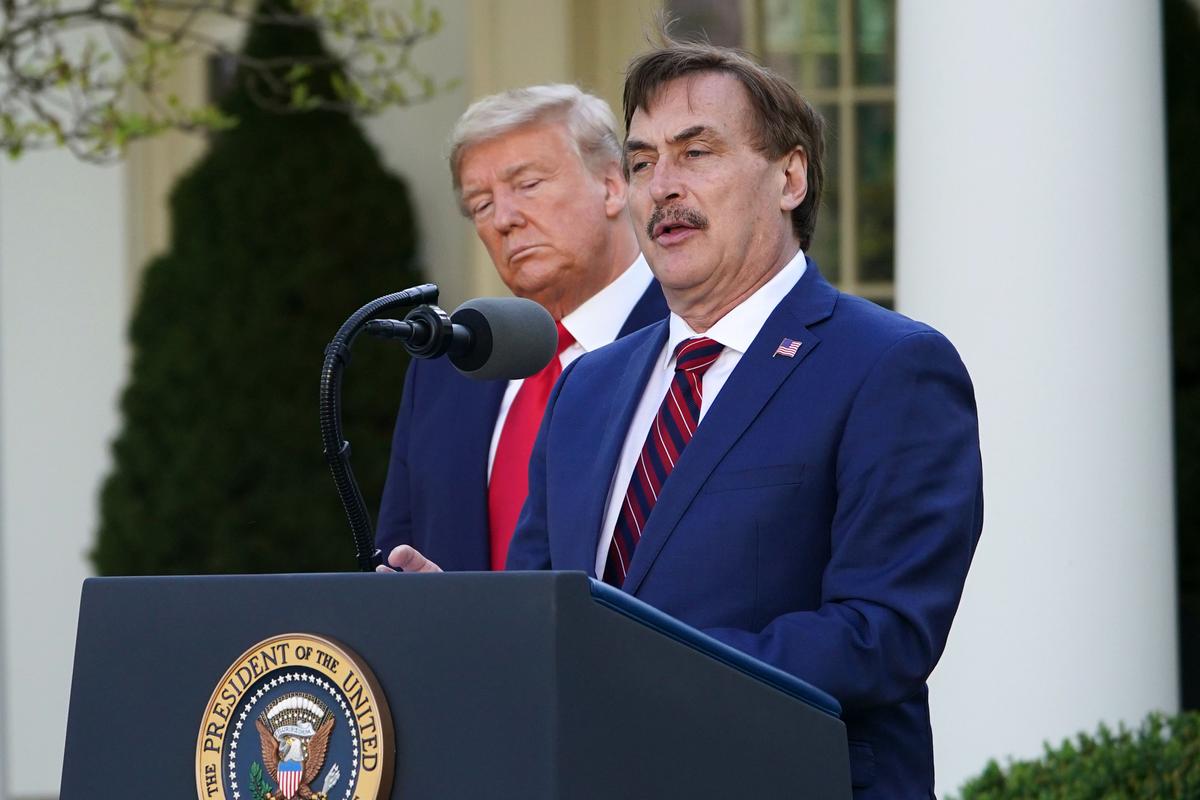 U.S. President Donald Trump listens as Michael J. Lindell, CEO of MyPillow Inc., speaks during the daily briefing on the novel coronavirus, which causes the disease COVID-19, in the Rose Garden of the White House in Washington, D.C., on March 30, 2020. (MANDEL NGAN/AFP via Getty Images)