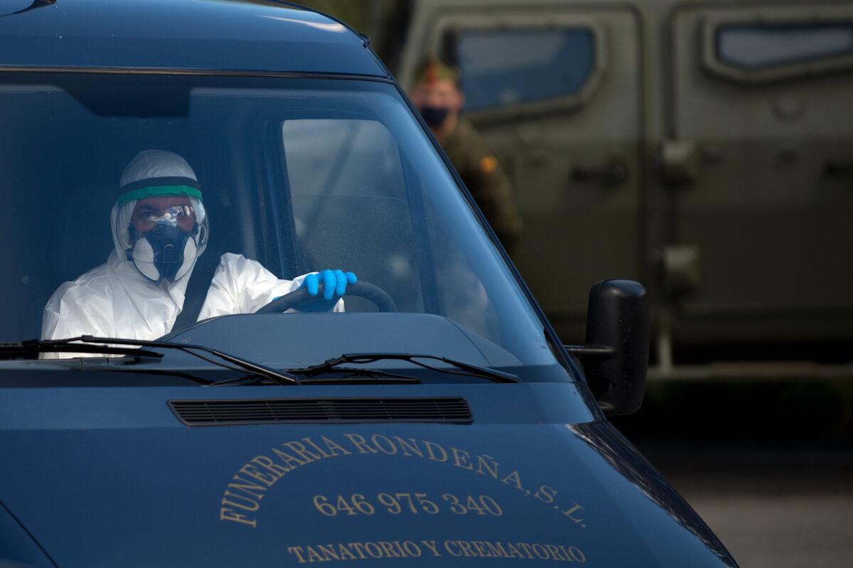 A mortuary worker in full protective gear drives a hearse in Ronda amid a national lockdown to prevent the spread of the CCP virus on April 3, 2020. (Jorge Guerrero/AFP via Getty Images)