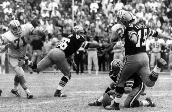 New Orleans Saints' Tom Dempsey (19) moves up to kick a 63-yard field goal as teammate Joe Scarpati holds the ball and Detroit Lions' Alex Karras (71) rushes in while Saints' Bill Cody (66) blocks, in New Orleans on Nov. 8, 1970. (AP Photo)