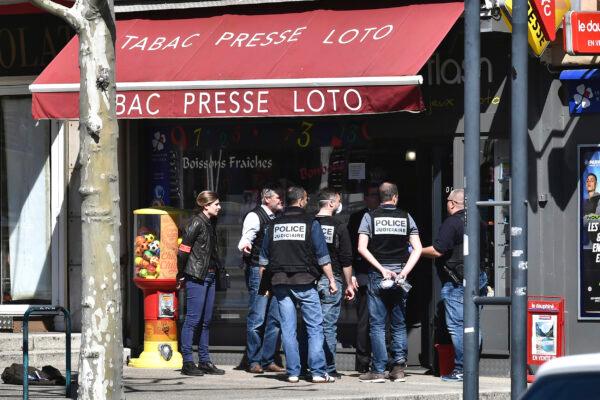 Police officers gather after a man wielding a knife attacked residents venturing out to shop in the town under lockdown, in Romans-sur-Isere, southern France on April 4, 2020. (AP Photo)