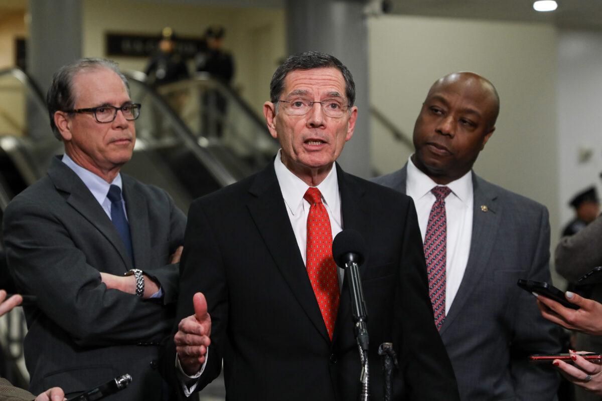 Sen. John Barrasso (R-Wy.) speaks to media as Sen. Mike Braun (R-Ind.) (L) and Sen. Tim Scott (R-S.C.) (R) look on, during a break in the impeachment trial of President Donald Trump at the Capitol in Washington on Jan. 29, 2020. (Charlotte Cuthbertson/The Epoch Times)
