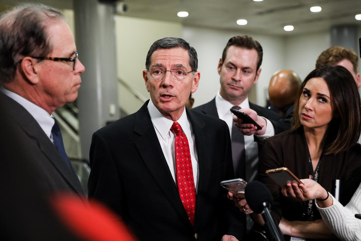 Sen. John Barrasso (R-Wy.) speaks to media while Sen. Mike Braun (R-Ind.) (L) looks on, at the Capitol in Washington on Jan. 27, 2020. (Charlotte Cuthbertson/The Epoch Times)