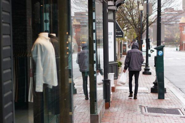 A lone man walks on M Street in the normally busy shopping district of Georgetown in Washington, on March 23, 2020. (Mandel Ngan/AFP via Getty Images)