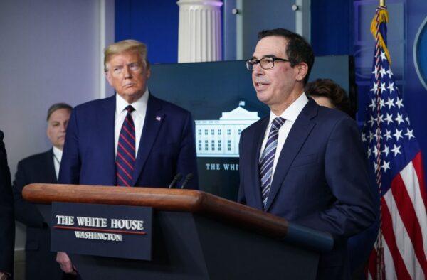U.S. Secretary of the Treasury Steven Mnuchin speaks while President Donald Trump listens during the daily briefing on COVID-19 in the Brady Briefing Room at the White House, on April 2, 2020. (Mandel Ngan/AFP via Getty Images)