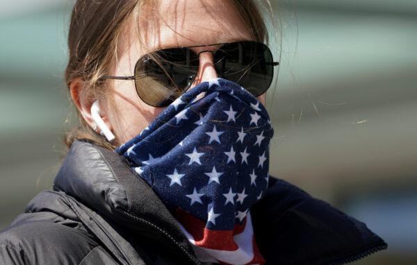 A woman wears a stars and stripes bandana for a face mask amid COVID-19 fears in Washington on April 2, 2020. (Kevin Lamarque/Reuters)