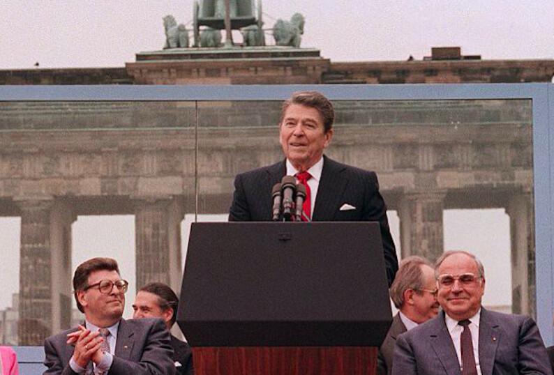 Then-President Ronald Reagan addresses the people of West Berlin at the base of the Brandenburg Gate in Berlin, on June 12, 1987. (Mike Sargent/AFP via Getty Images)