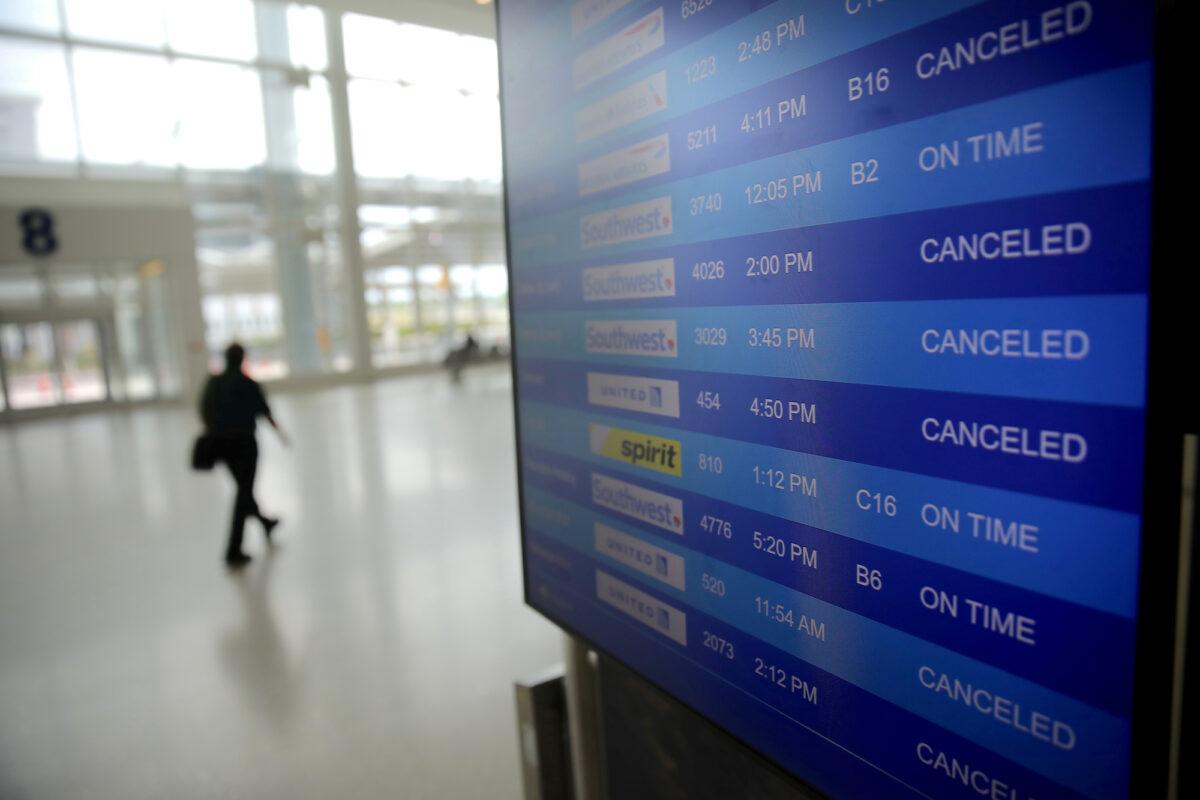 Canceled flights are seen on an airport screen as the spread of COVID-19 continues, in New Orleans, La., on April 4, 2020. (Reuters/Carlos Barria)
