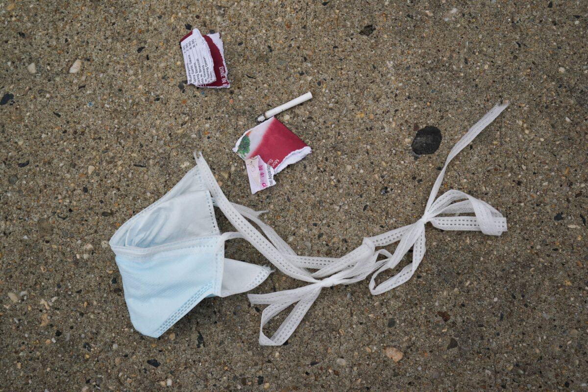 A discarded surgical mask is seen on the sidewalk outside of Wyckoff Hospital in the Bushwick section of Brooklyn, New York City, in a file photo. (Bryan R. Smith/AFP via Getty Images)