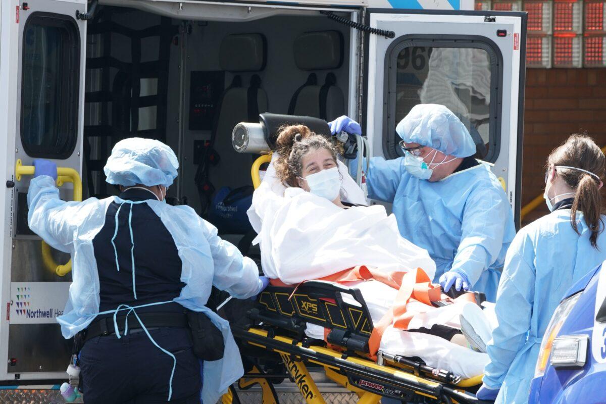 A woman arrives by ambulance to Wyckoff Hospital in the Bushwick section of Brooklyn in New York on April 5, 2020 . (Bryan R. Smith/AFP via Getty Images)