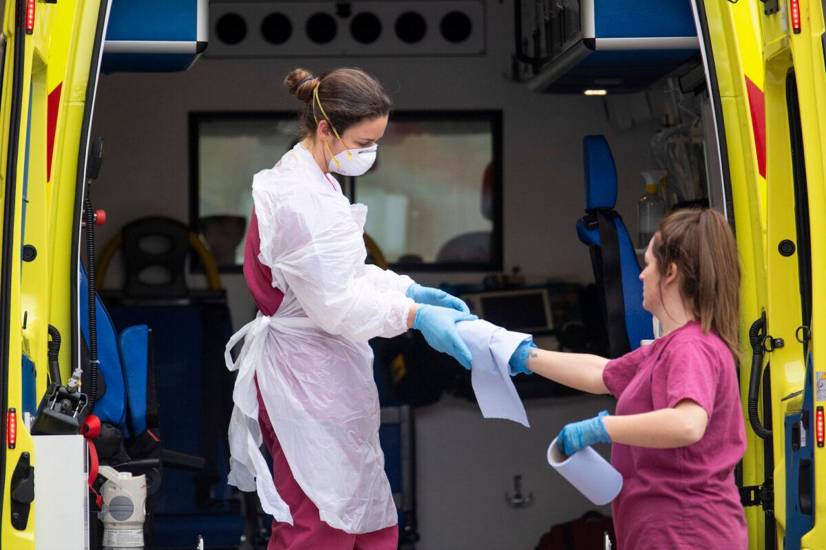 A hospital worker cleans an ambulance outside St. Thomas' hospital in London, England, on April 1, 2020. (Justin Setterfield/Getty Images)