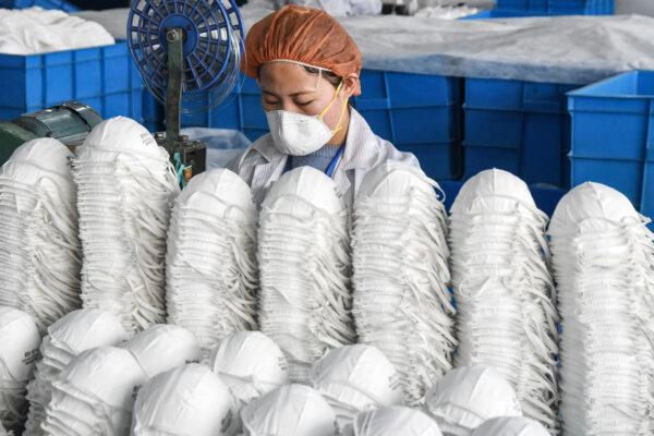 A worker producing protective masks at a factory in Handan city, Hebei province, China on Feb. 28, 2020. (STR/AFP via Getty Images)