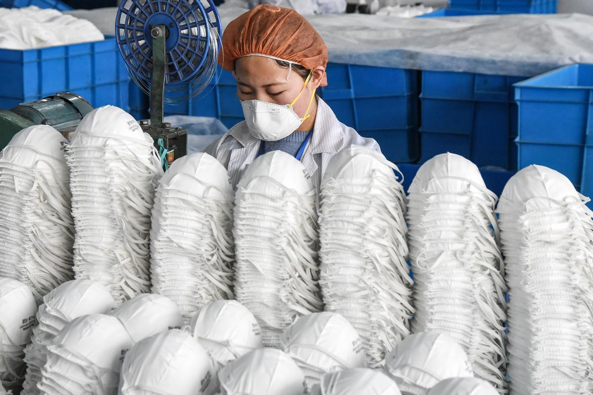 A worker producing protective masks at a factory in Handan city, Hebei province, China, on Feb. 28, 2020. (Str/AFP via Getty Images)