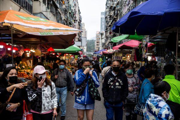  People walk through a market in Hong Kong on March 29, 2020. (Issac Lawrence/AFP via Getty Images)