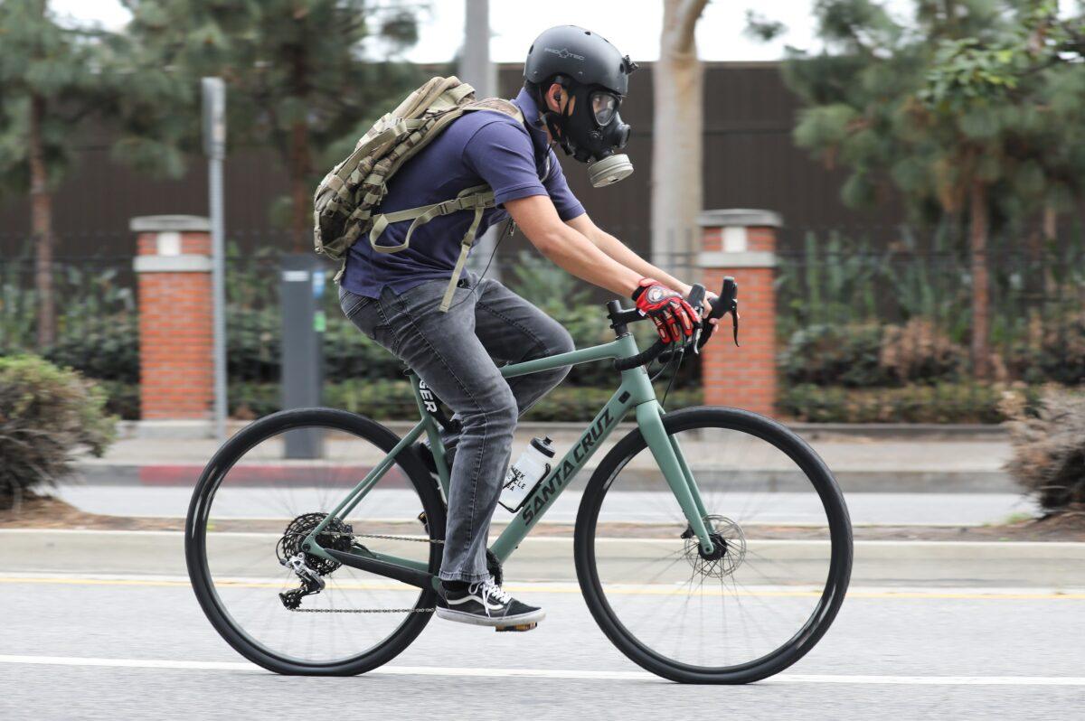 A man wears a gas mask while riding a bike amid the COVID-19 pandemic in Los Angeles, California, on April 6, 2020. (Mario Tama/Getty Images)