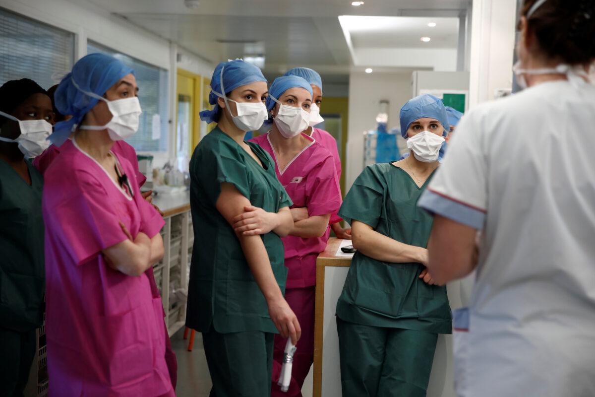 Medical staff attend a briefing at the intensive care unit for COVID-19 patients at a hospital in Paris on April 6, 2020. (Benoit Tessier/Reuters)