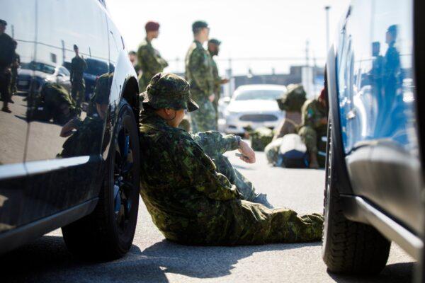Members of the Canadian Forces wait to convoy to CFB Borden amid the spread of the CCP virus in Toronto on April 6, 2020. (Cole Burston/Getty Images)