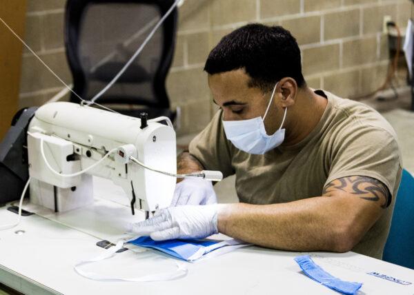 A parachute rigger with 1st Special Forces Group (Airborne), Group Support Battalion, sews surgical masks for medical patients at Joint Base Lewis-McChord, Wash., on March 31, 2020. (U.S. Army photo by SGT Joe Parrish)