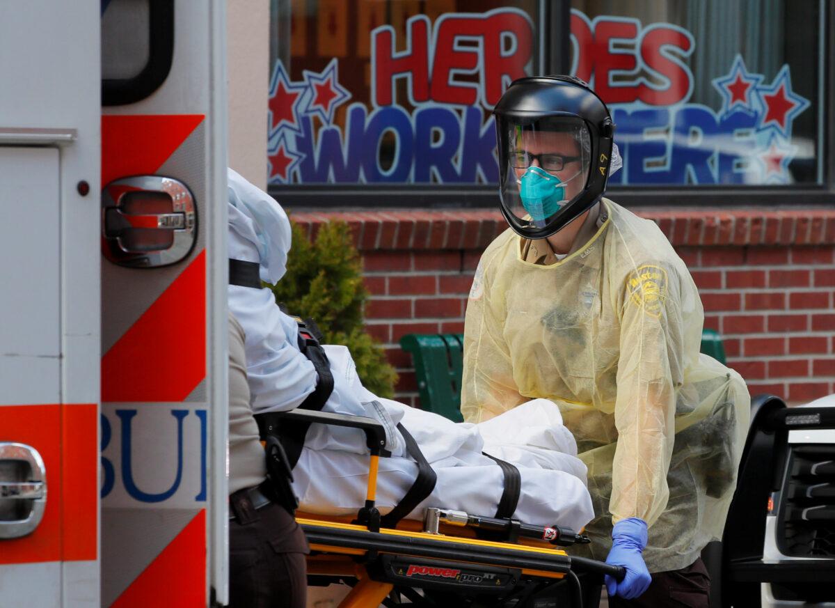 Paramedics wearing personal protective equipment transport a patient amid COVID-19 outbreak in Boston, Massachusetts, on April 7, 2020. (Reuters/Brian Snyder)