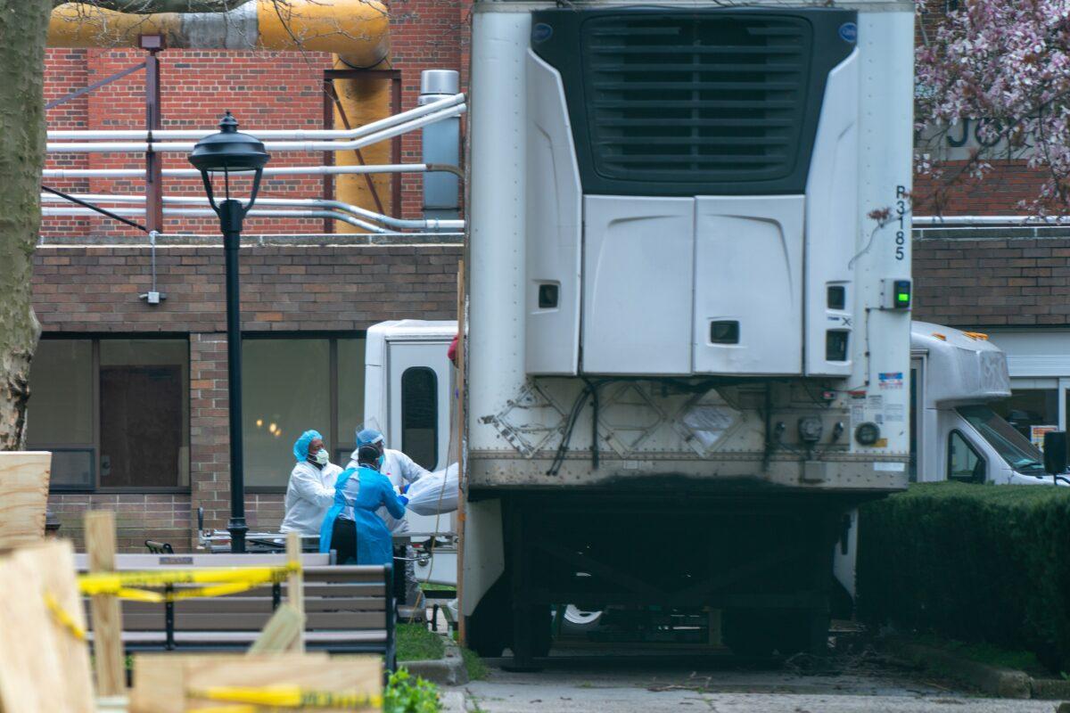 Kingsbrook Jewish Medical Center employees transport a deceased patient to a refrigerated truck in the Brooklyn borough of New York City on April 8, 2020. (David Dee Delgado/Getty Images)