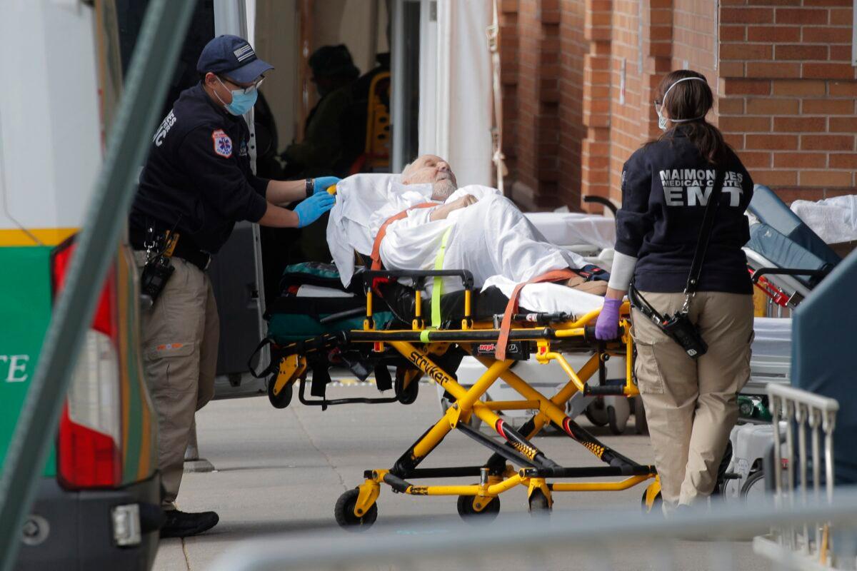 Paramedics take a patient into a hospital during the outbreak of the CCP virus in the Brooklyn borough of New York City, New York on April 7, 2020. (Brendan Mcdermid/Reuters)