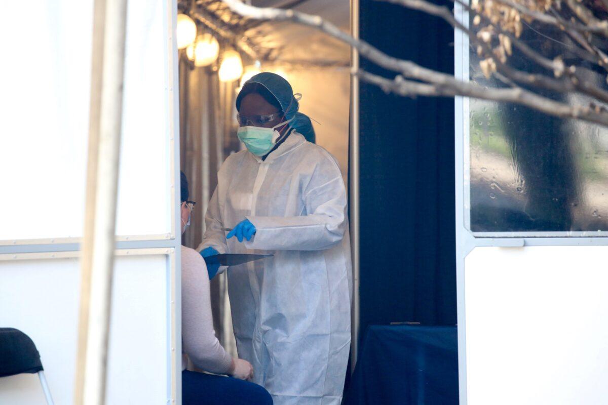 Medical professionals see walk-in patients at a COVID-19 testing tent on the grounds of the George Washington University Hospital during the COVID-19 pandemic in Washington on April 7, 2020. (Jonathan Ernst/Reuters)
