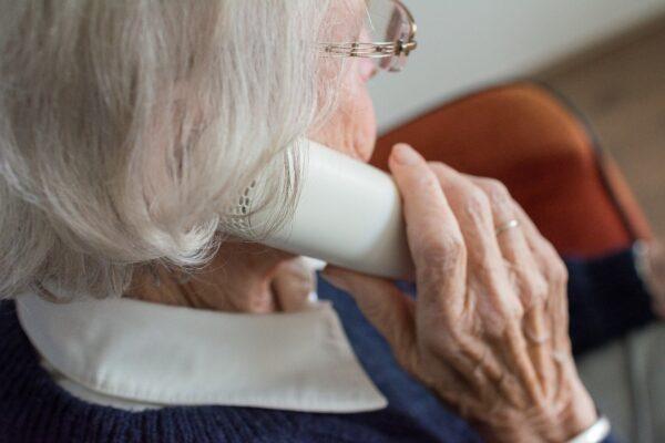 A file photo of an elderly woman holding a phone. (Sabine van Erp/Pixabay)