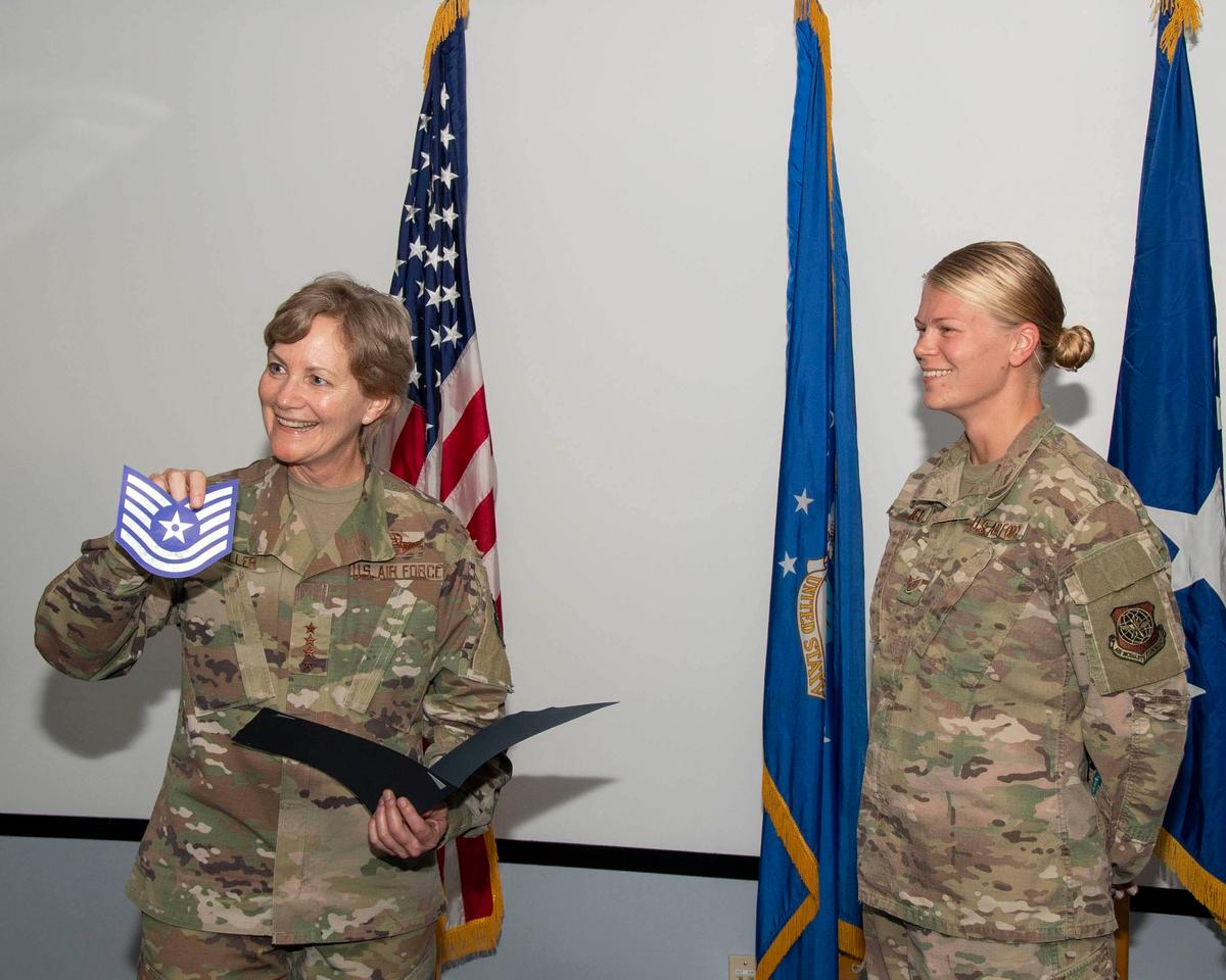 Gen. Maryanne Miller presents Staff Sgt. Kayla D. Lee a promotion certificate while visiting the 916th Air Refueling Wing on Seymour Johnson Air Force Base, North Carolina, Sept. 10. (<a href="https://www.dvidshub.net/image/5746784/911th-air-refueling-squadron-welcomes-amc-commander-miller">Staff Sgt. Mary McKnight</a>/DVIDSHUB)
